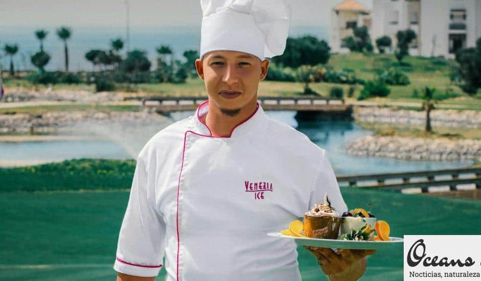 woman in white chef uniform holding green plate with food