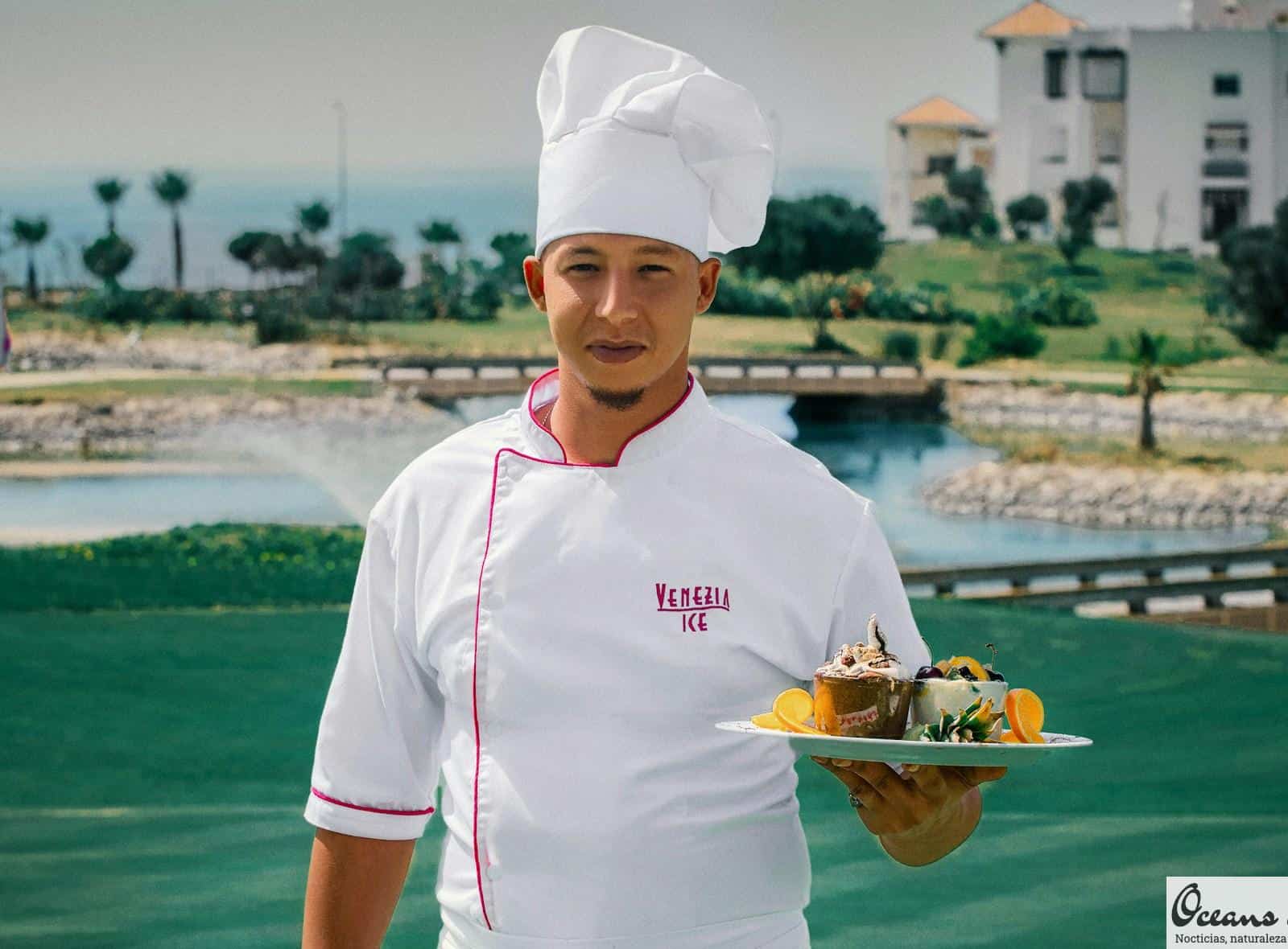 woman in white chef uniform holding green plate with food