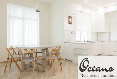 Spacious and airy dining room with modern minimalist decor, featuring wooden furniture and natural light.