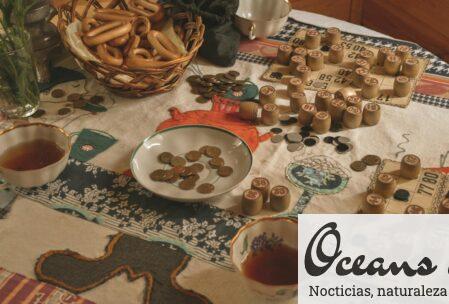 A cozy setting with bingo game elements, snacks, and tea on a table.