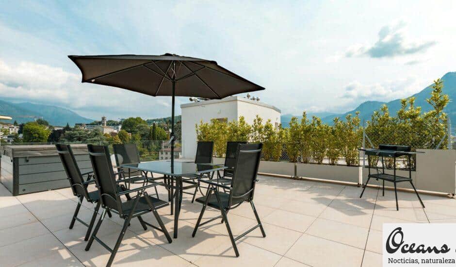 Sunny terrace with furniture, umbrella, and mountain views. Ideal for outdoor relaxation.