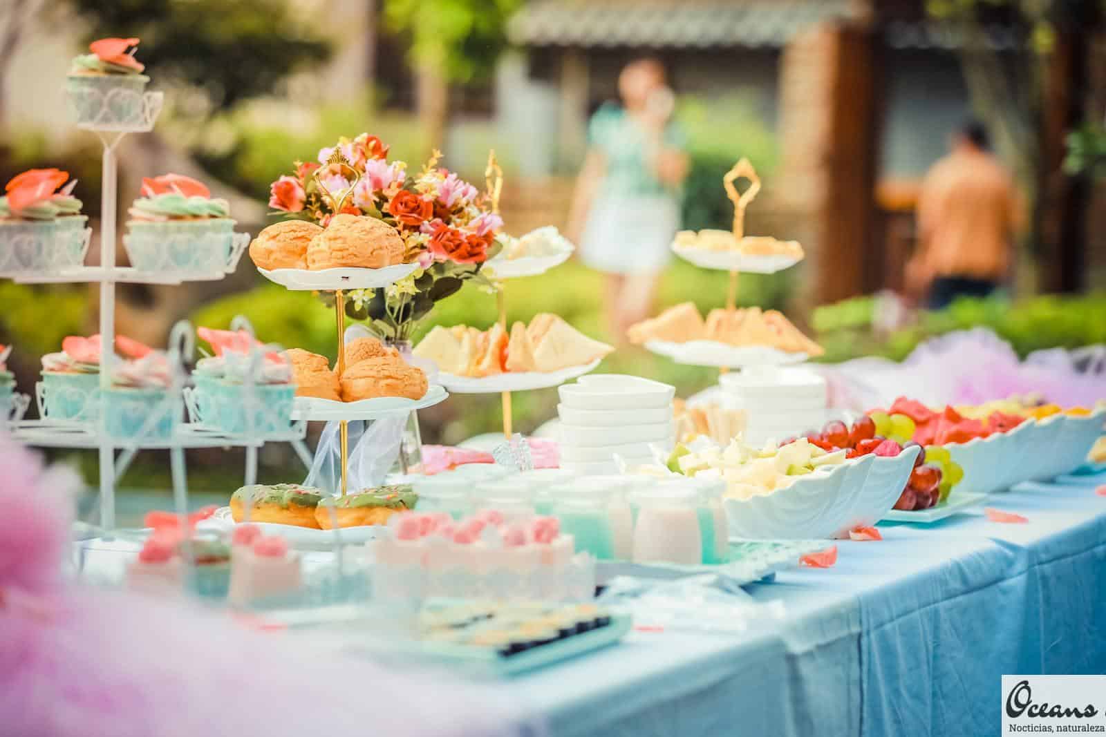 A vibrant outdoor buffet table showcasing an array of colorful pastries and fruits, perfect for parties.