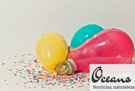 Vibrant colorful balloons surrounded by confetti, perfect for party celebrations.