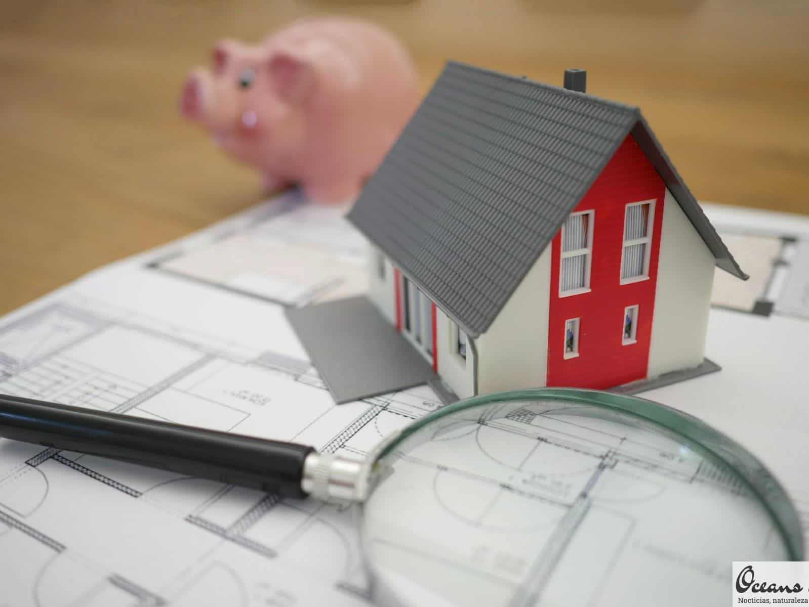 white and red wooden house beside grey framed magnifying glass